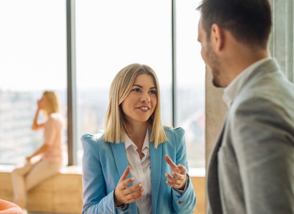 Two colleagues discussing strategic travel management