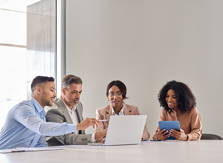 A group of employees discussing corporate travel